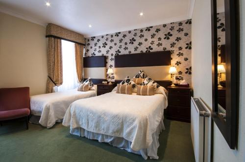 a hotel room with two beds and a window at South Beach Hotel in Troon