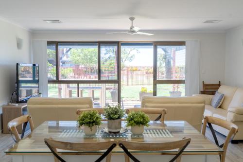 a living room with a table and chairs at The Gums Anchorage in Bellara