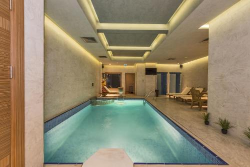 a swimming pool in a house with a living room at The Meretto Hotel Istanbul Old City in Istanbul