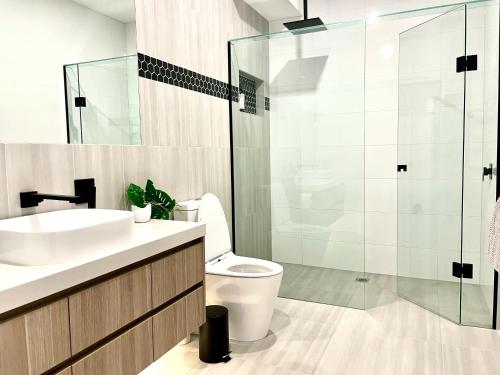 a bathroom with a toilet and a glass shower at Your home on Glover St Sth Melbourne (With Parking) in Melbourne