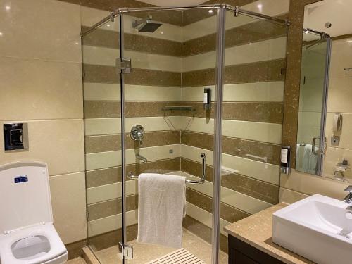 a bathroom with a shower and a toilet and a sink at Fortune Park, Haridwar - Member ITC's Hotel Group in Haridwār