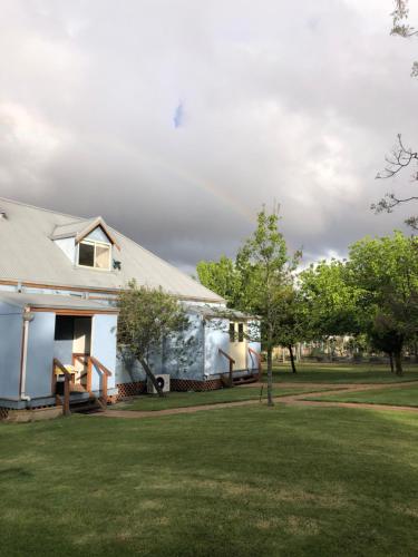 a white house with a yard and trees at Mondurup Escape - Kendenup in Kendenup