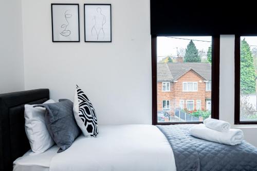 a bedroom with a white bed and a window at Free Parking - Large House - Contractor - Leisure in Birmingham