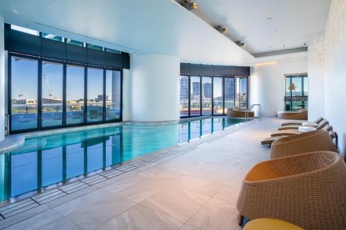a swimming pool in a building with windows at CASSA ONE - Luxury Apartments Managed by The Cassa in Brisbane
