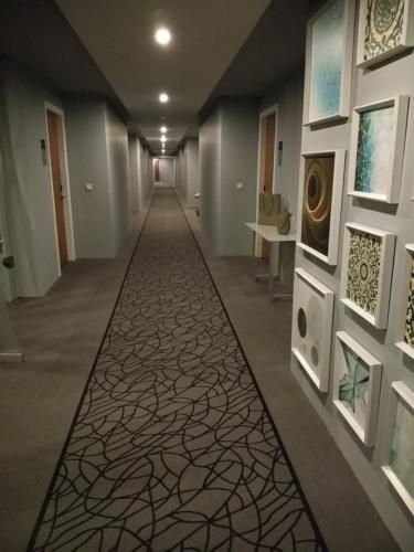 a hallway with a carpeted floor in a building at West Inn Hotel Faisalabad in Faisalabad
