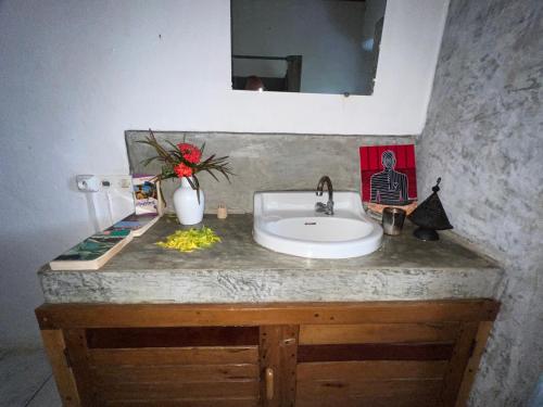 a bathroom counter with a sink and a mirror at Corto Novo Maison d'hôtes-Camping in Nosy Be