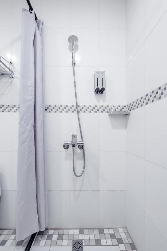 a bathroom with a shower with a shower curtain at Taitung Chun Yang Inn in Taitung City