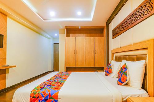 a bedroom with a large bed in a room at FabHotel Keerthi's Anupama - Nr Indira Gandhi Stadium in Vijayawāda