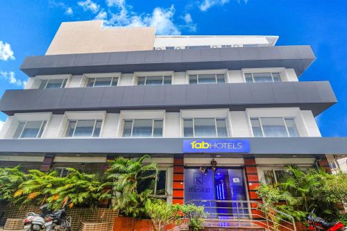 a building with a go hotels sign in front of it at FabHotel Keerthi's Anupama - Nr Indira Gandhi Stadium in Vijayawāda