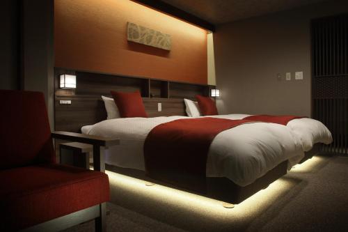 a bedroom with a large bed with lights on it at Yuuyu No Sato Yusa in Yamagata