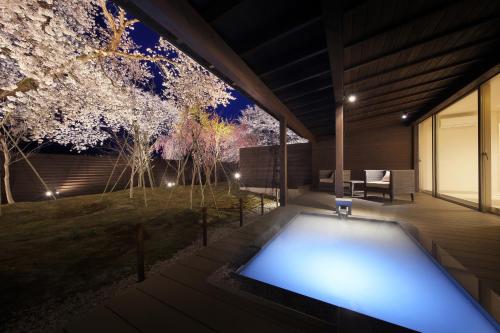 a swimming pool in the backyard of a house at night at Yuuyu No Sato Yusa in Yamagata