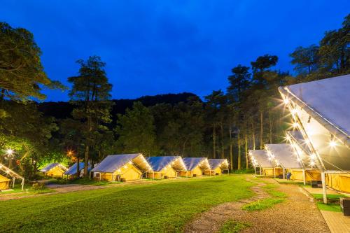 a row of tents in a field at night at Lapopo in Keelung