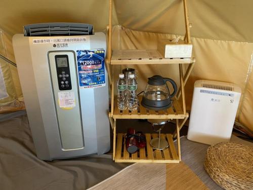 a refrigerator and a shelf in a tent at Lapopo in Keelung