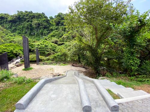 a road in the middle of a forest with a tree at Lapopo in Keelung