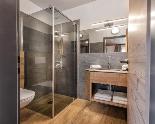 a bathroom with a shower and a sink at Jugendgästehaus Gruber in Grossarl