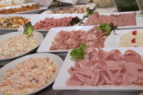 a buffet of different types of food on plates at Hotel Villa Ducale in Parma
