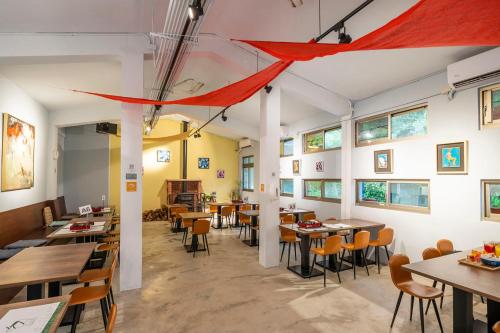 a restaurant with tables and chairs and a red canopy at Lapopo in Keelung