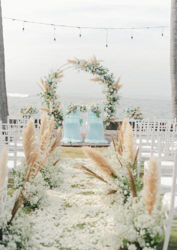 a wedding altar with blue vases and white flowers at Villa Samudra Luxury Beachfront in Ketewel