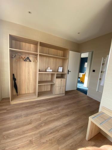 a room with wooden shelves and wooden floors at L'Huitrière in Quiberville