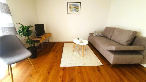 a living room with a couch and a table at Donauhosting, Stadt Land Fluss in Unterkirchberg