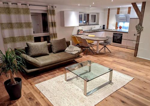 a living room with a couch and a table at Donauhosting, Stadt Land Fluss in Unterkirchberg