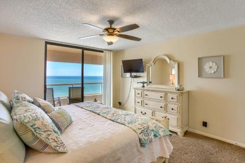 a bedroom with a bed and a dresser with a mirror at 12B Crescent Beach Club in Clearwater Beach