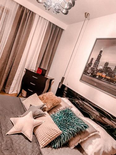 a bedroom with a bed with pillows on it at Apartament Solna 80 - Centrum Miasta przy Promenadzie in Kielce