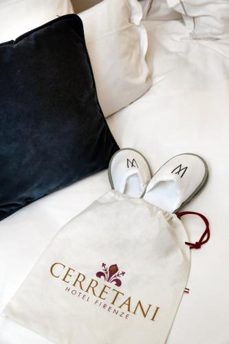 a pair of hearts towels on a bed at Cerretani Hotel Firenze - MGallery Collection in Florence