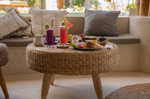 a rattan table with a tray of food on it at Villa Tokay - The Luxury Resort in Gili Air