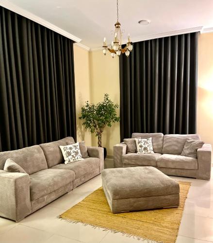 a living room with two couches and a couch at Independent Spacious 3 Bedroom Villa in Dubai