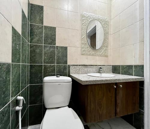 a bathroom with a toilet and a sink at Independent Spacious 3 Bedroom Villa in Dubai