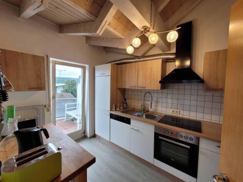 a kitchen with a sink and a stove top oven at Ferienwohnung Hegau in Hilzingen