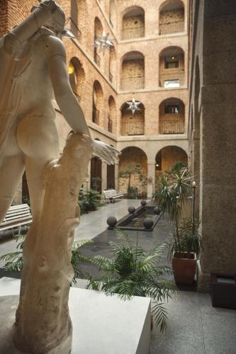 a statue of a woman standing in a building at Parador de La Granja in La Granja de San Ildefonso