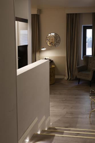 a hallway with a living room with a table at Cerretani Hotel Firenze - MGallery Collection in Florence