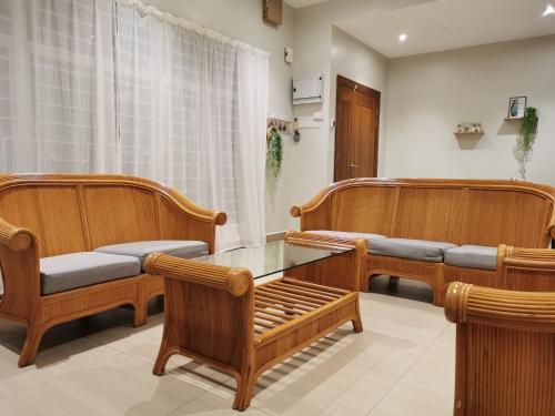 a waiting room with wooden benches and a table at 28 Residence Homestay in Melaka