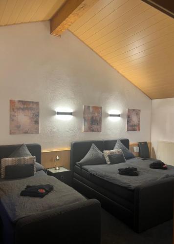 a living room with two beds and a couch at Hotel zur Wasserburg in Kerpen