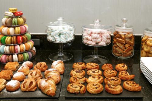 un montón de diferentes tipos de pan y repostería en Hotel Cerretani Firenze - MGallery Collection en Florence