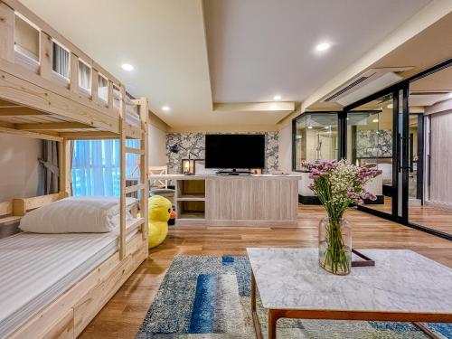 a bedroom with a bunk bed and a tv at Oakwood Hotel & Residence Bangkok SHA Plus Certified in Bangkok