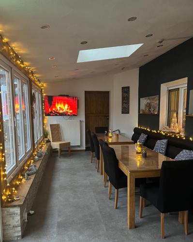 a dining room with tables and chairs and lights at Hotel zur Wasserburg in Kerpen