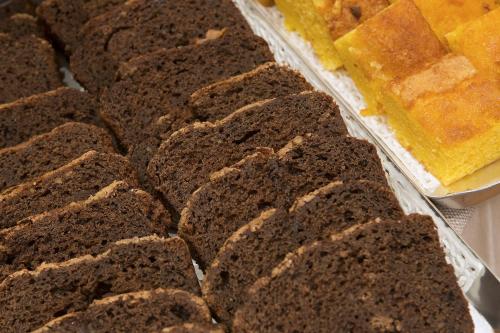 a tray of brownies and a plate of yellow cake at Hotel Villa Ducale in Parma