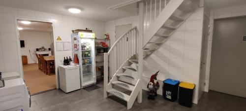 a kitchen with a staircase next to a refrigerator at Antonius Hoeve in Oudenbosch
