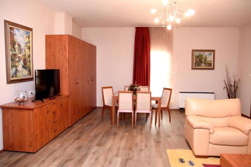 a living room with a table and a dining room at Sveta Sofia Hotel in Sofia