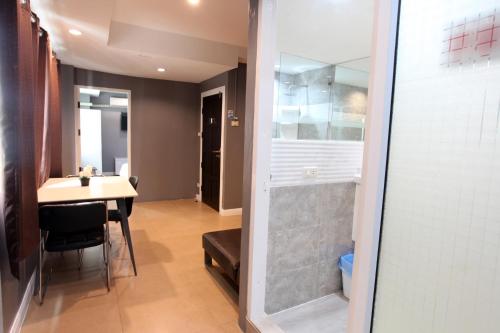a bathroom with a shower and a sink and a toilet at Del Mar Rooms in Pattaya South