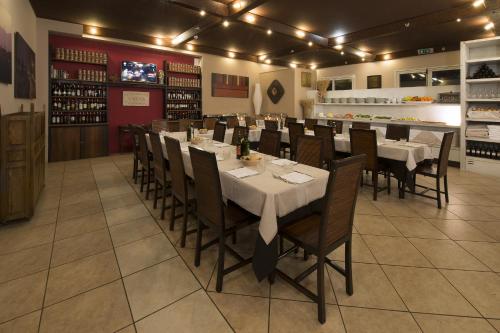 a restaurant with tables and chairs in a room at Hotel Villa Ducale in Parma