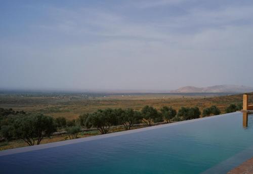 a swimming pool with a view of a field at Dar Imiri in Ourika