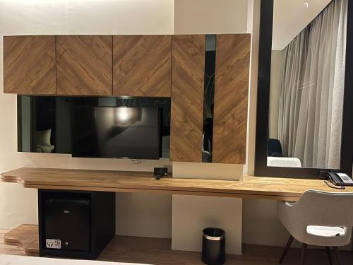 a desk with a television and a mirror at Grand Central Premier in Medan