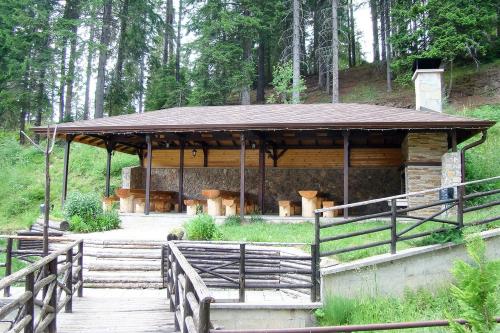a pavilion in a forest with a wooden walkway at Спа,ски апартамент Дайли, Стрийм Ризорт Пампорово in Pamporovo