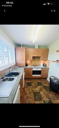 a kitchen with a sink and a stove top oven at Lovely entire 2 Bedroom apartment in Monifieth