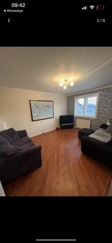 a living room with two couches and a hard wood floor at Lovely entire 2 Bedroom apartment in Monifieth