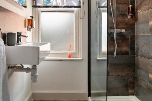 a bathroom with a sink and a shower at Finest Retreats - Sunnycroft Penthouse in Llandrindod Wells